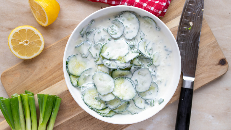 Creamy cucumber salad with green onions and lemon