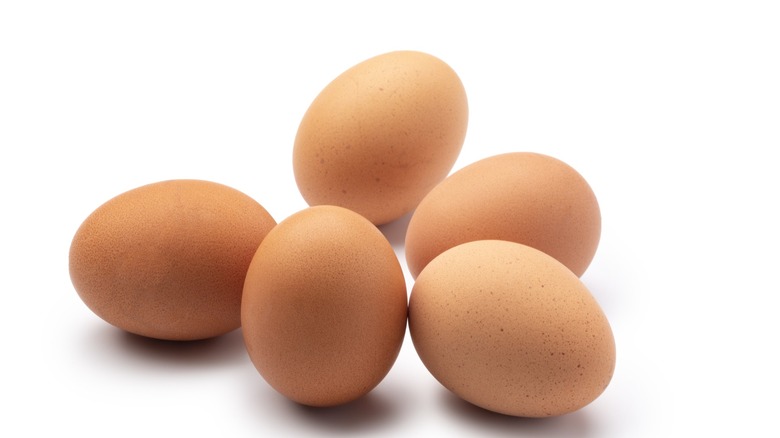 Five eggs on white background