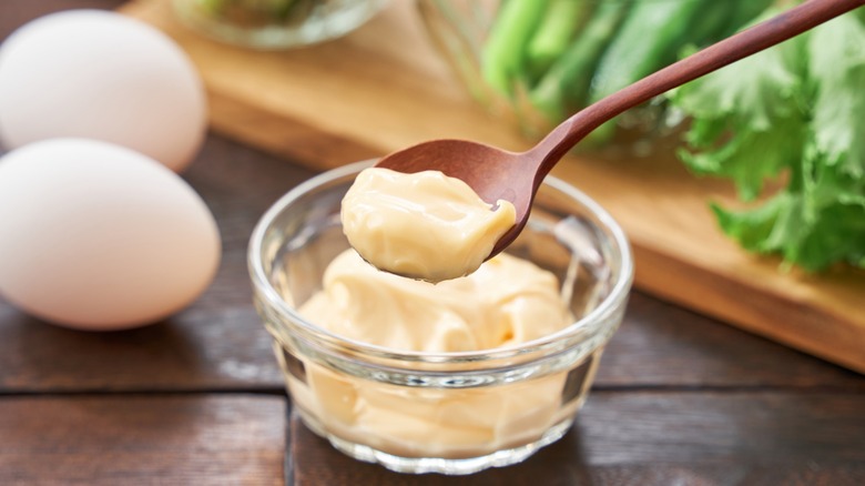 A close-up shot of mayonnaise in a small glass bowl