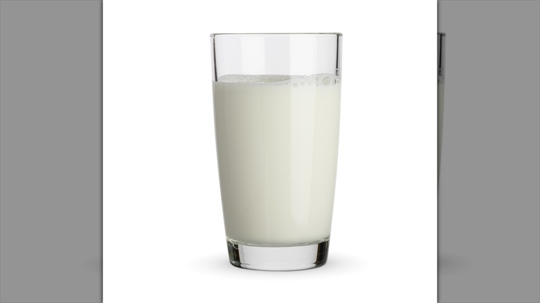 Glass of milk on white background