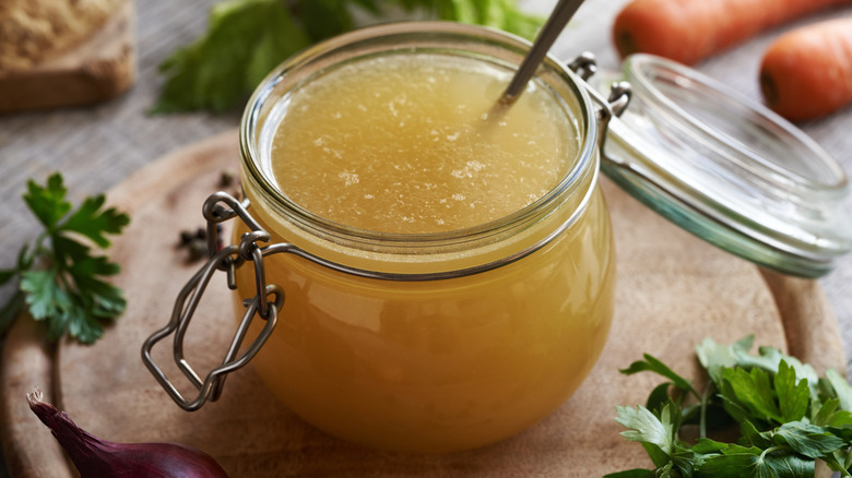 A luxurious chicken stock in a glass, resealable container