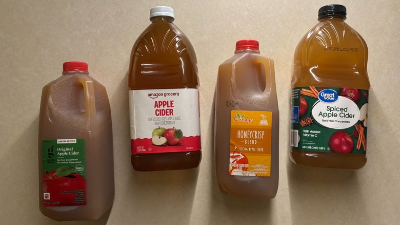 Bottles of four apple cider brands on a counter