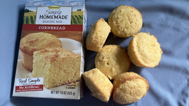 A pile of Fleischmann's Simply Homemade cornbread muffins next to the box of muffin mix.