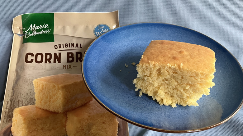 A plate of Marie Callender's cornbread next to the cornmix package.