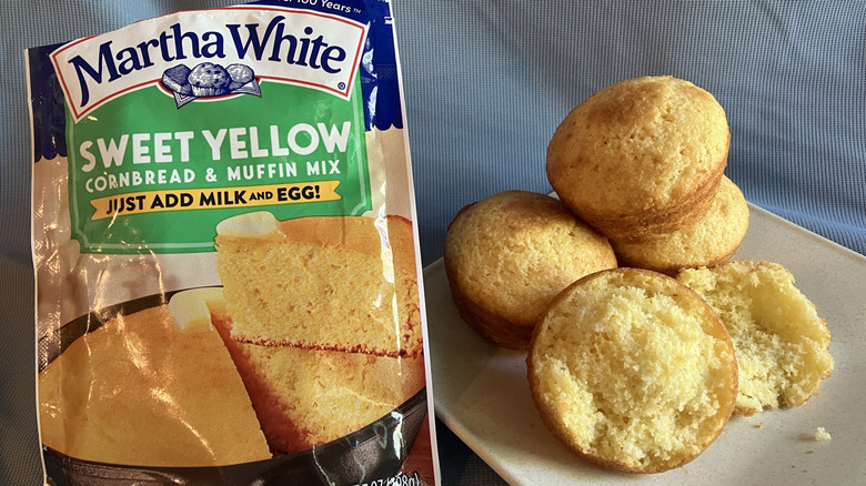 A plate of Martha White Sweet Yellow cornbread muffins next to the packaging.