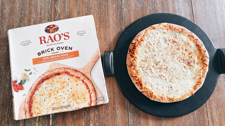 Rao's brick oven five cheese frozen pizza next to box on wooden table