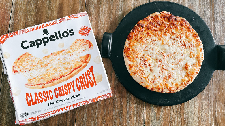 Cappello's classic crispy crust frozen pizza next to box on wooden table