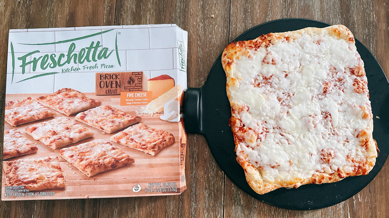 Freschetta Brick Oven Crust Five cheese frozen pizza next to box on wooden table