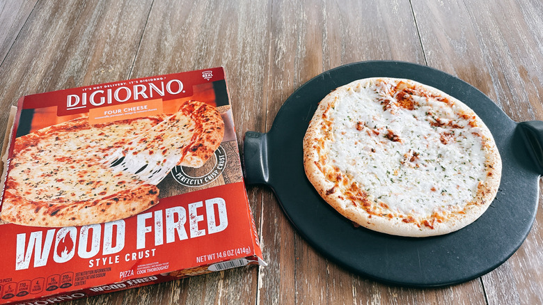DiGiorno wood fired frozen cheese pizza next to box on wooden table