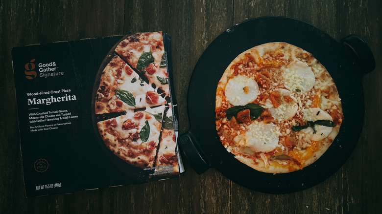 Good & Gather frozen margherita pizza next to box on wooden table