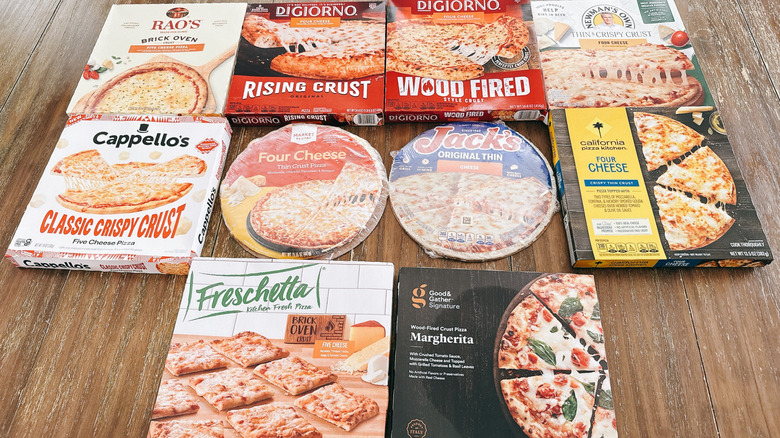 10 store-bought frozen cheese pizza boxes on wooden table