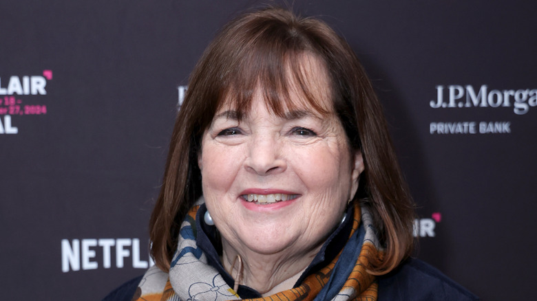 Ina Garten smiling wearing a scarf at a public event