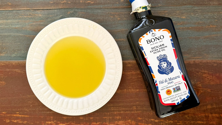 Bono Extra Virgin Olive Oil bottle next to a dish with oil