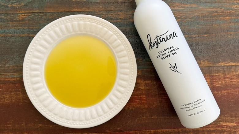Kosterina Extra Virgin Olive Oil bottle next to a dish with oil