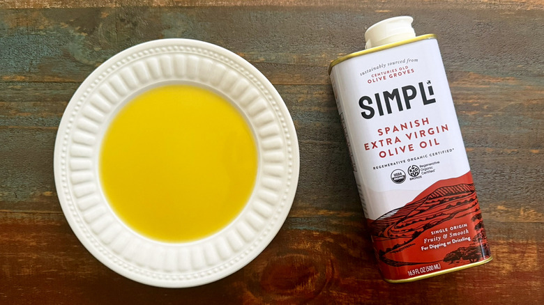 Simpli Extra Virgin Olive Oil bottle next to a dish with oil