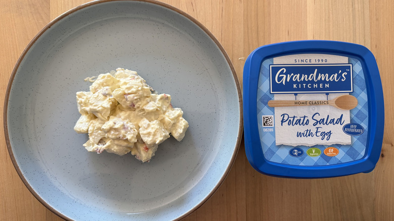 potato salad on blue plate next to blue plastic container