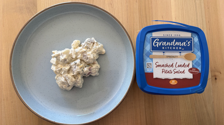 potato salad on blue plate next to blue plastic container