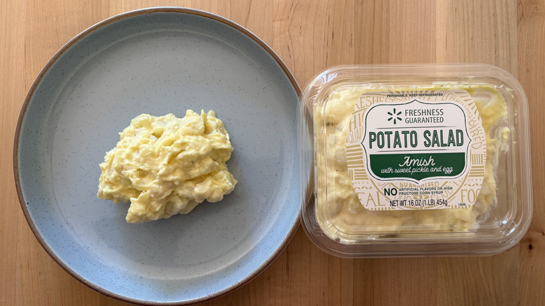 potato salad on blue plate next to plastic container of potato salad