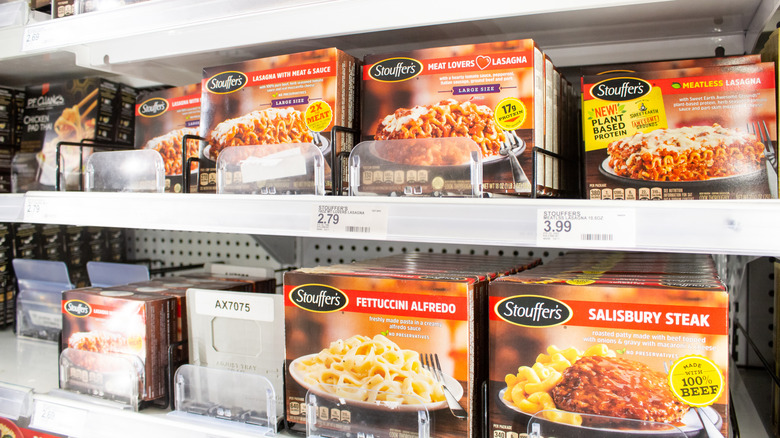 A grocery store shelf full of various Stouffer's meals.