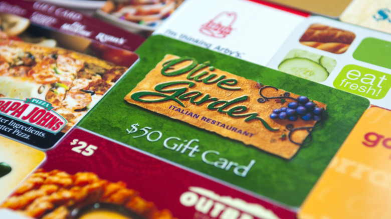 A closeup of various restaurant gift cards including Olive Garden, Papa Johns, and Outback Steakhouse