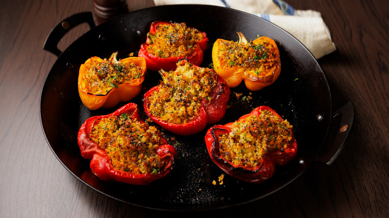 Stuffed red and yellow peppers on an iron skillet