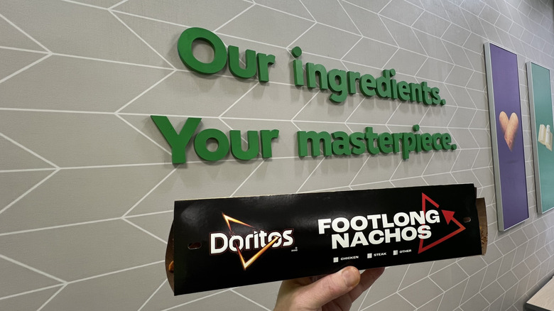 Subway's Doritos Footlong Nachos in front of a wall with words