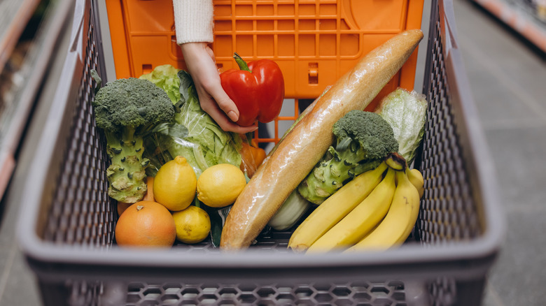 woman placing groceries in cart