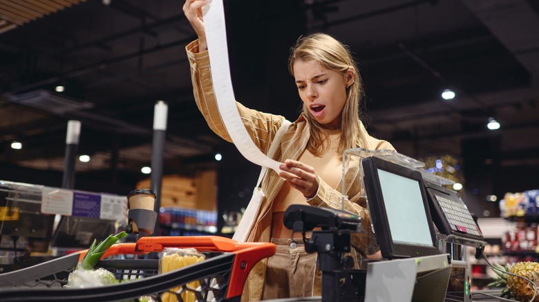 Person alarmed by grocery bill in store