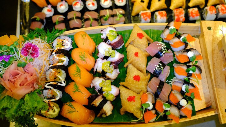 Wooden tray filled with sushi buffet rolls