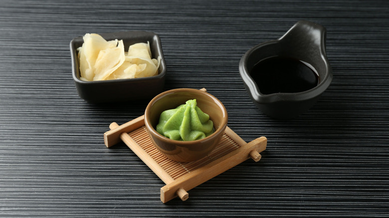 Wasabi, ginger, and soy sauce on black table