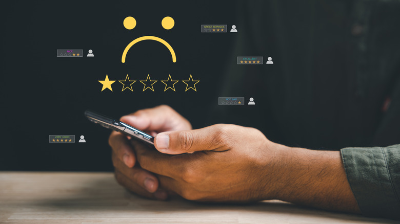 Person reads screen with mix of good and bad reviews
