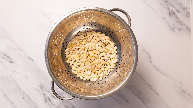 Colander with pumpkin seeds
