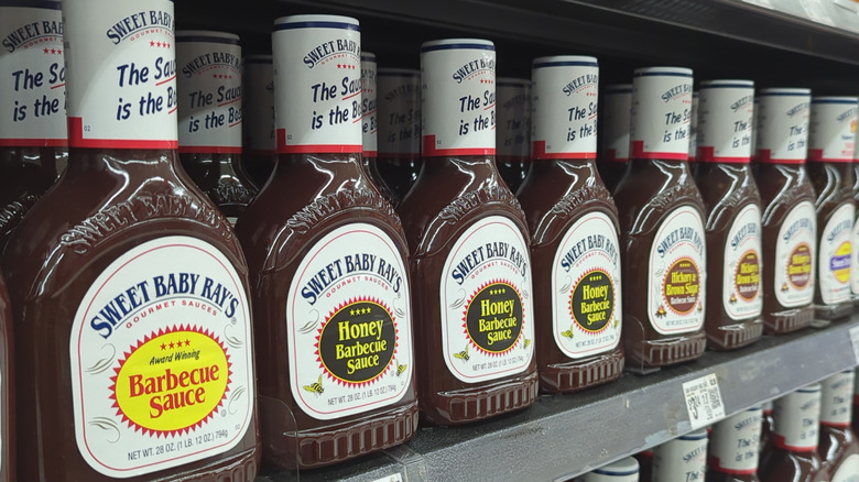 A row of Sweet Baby Ray's barbecue sauces on a store shelf