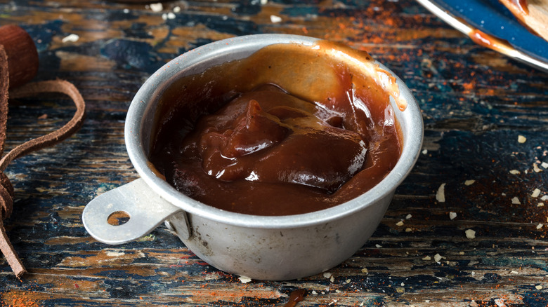 Barbecue sauce in metal measuring cup