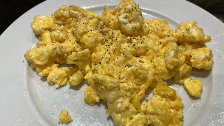 Seasoned scrambled eggs on a white plate