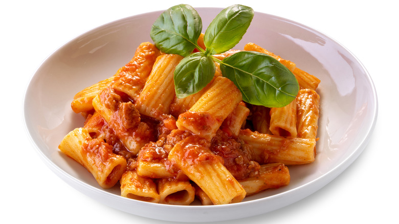 Rigatoni with meat sauce and fresh basil