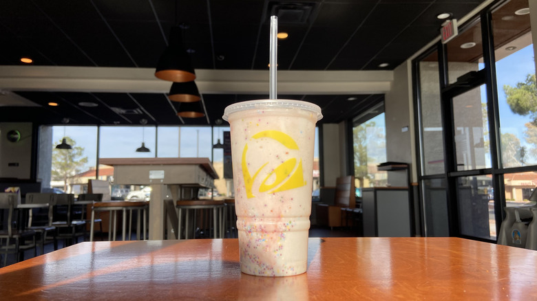 the Confetti Cookie Freeze on a table in a Taco Bell