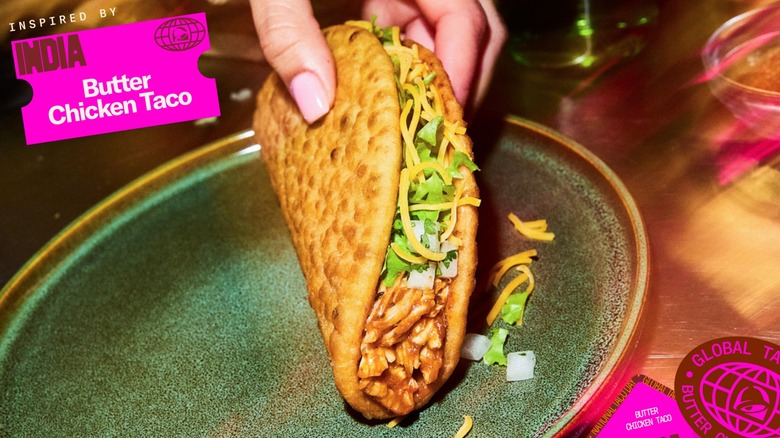 Person holding Taco Bell's Butter Chicken Taco