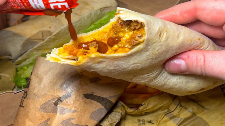 Taco Bell burrito with hot sauce