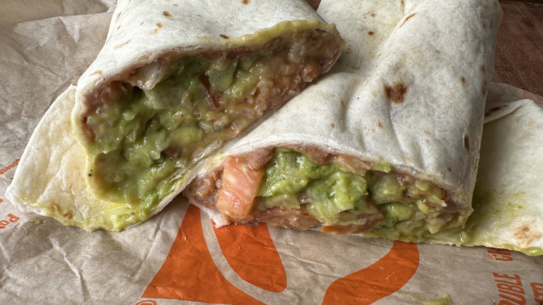 Taco Bell 7-layer burrito cut in half
