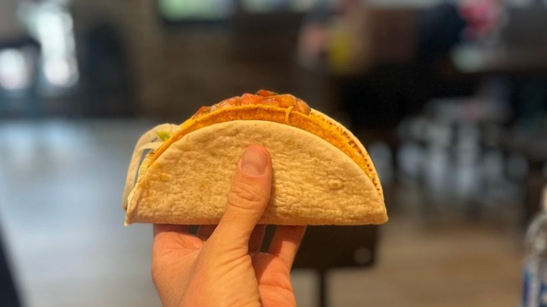 Hands holds a Tajín Cheesy Gordita Crunch