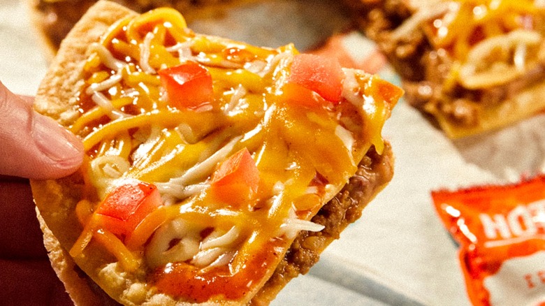 Person holding Taco Bell's Mexican Pizza