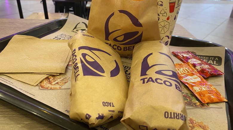 Taco Bell items in wrappers on tray