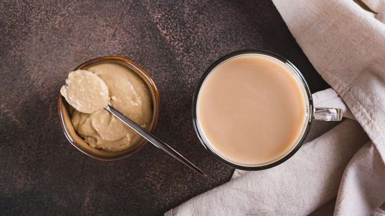tahini latte with tahini paste and a crumpled beige napkin