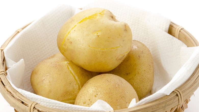 Steamed potatoes in a basket lined with a paper towel