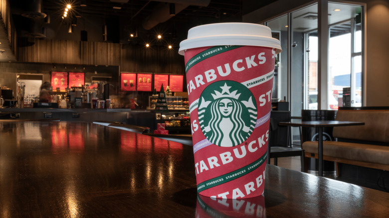 A green and red fall-themed Starbucks coffee