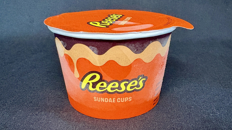 A sealed orange-colored Reese's ice cream sundae cup