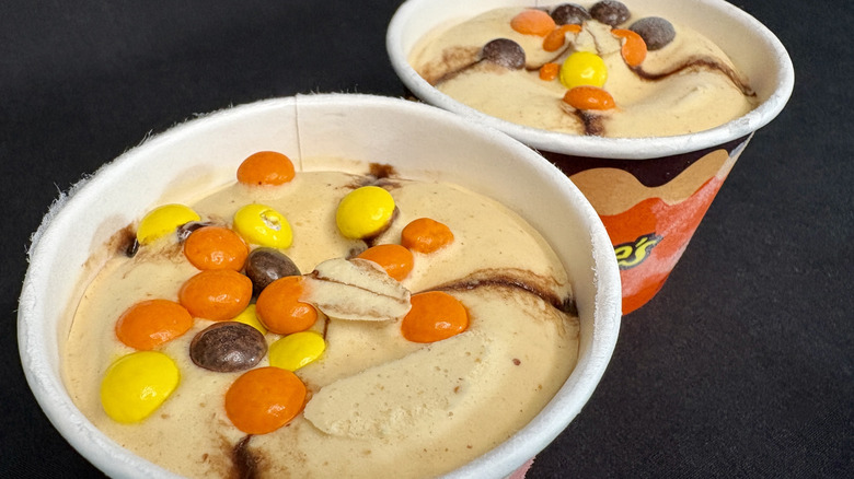 Top view of two ice cream cups topped with candy