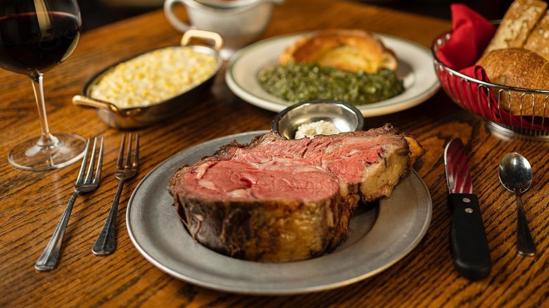 Gulliver's prime rib dinner with cream corn, creamed spinach, Yorkshire pudding, and whipped horseradish