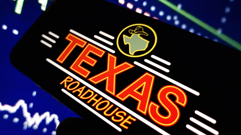 A smartphone with the Texas Roadhouse logo